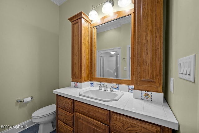 bathroom featuring crown molding, vanity, and toilet