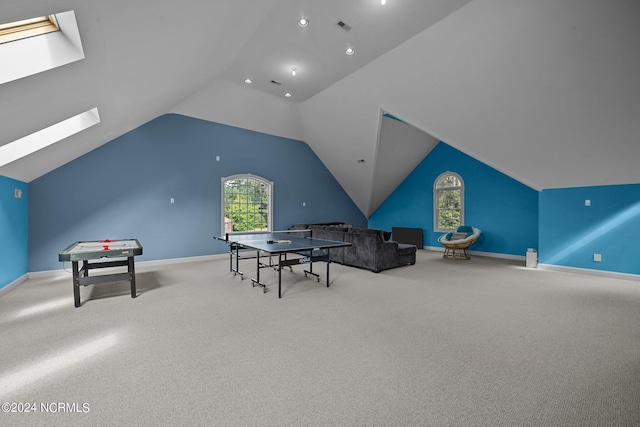 game room with carpet flooring, lofted ceiling with skylight, and a wealth of natural light