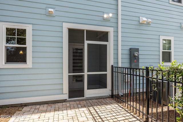 entrance to property featuring cooling unit