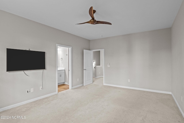 unfurnished bedroom with ensuite bathroom, ceiling fan, and light colored carpet