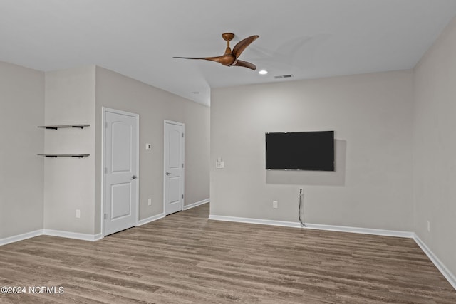 interior space with hardwood / wood-style floors and ceiling fan