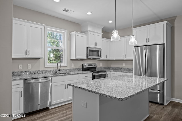 kitchen featuring white cabinetry, sink, a center island, and appliances with stainless steel finishes