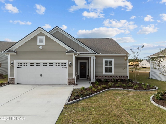 craftsman house with a front yard and a garage