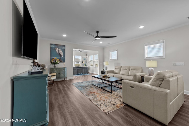 living room featuring ornamental molding, dark hardwood / wood-style floors, and plenty of natural light