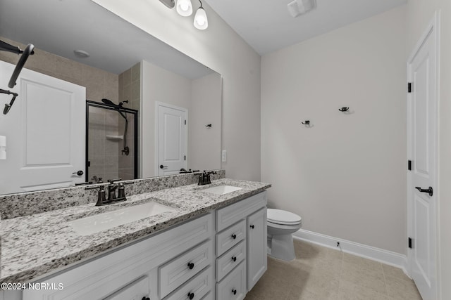 bathroom with a shower with door, vanity, toilet, and tile patterned flooring