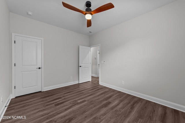 unfurnished bedroom with dark wood-type flooring and ceiling fan