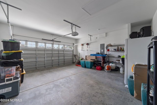 garage with a garage door opener and electric panel