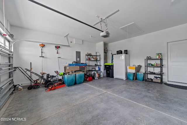 garage featuring a garage door opener, electric panel, and white refrigerator