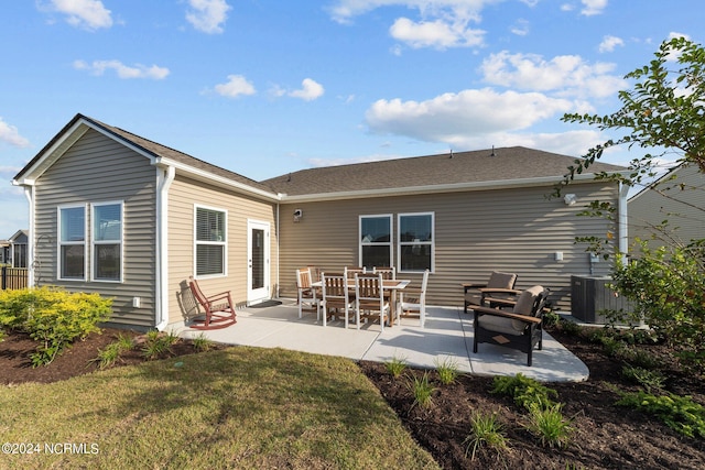 rear view of house featuring central air condition unit, a patio area, and a yard