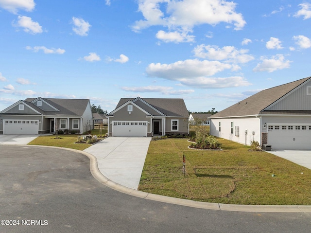 view of front of home with a front yard and a garage