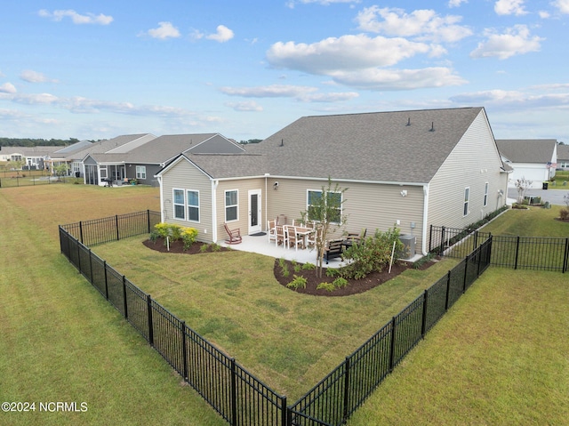 rear view of property with a patio area and a yard