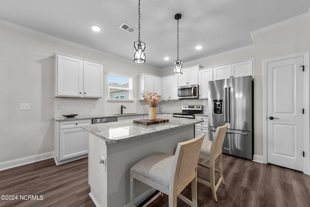 kitchen featuring a center island, appliances with stainless steel finishes, white cabinetry, and dark hardwood / wood-style flooring