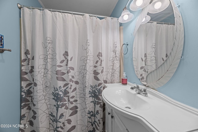 bathroom featuring vanity and curtained shower