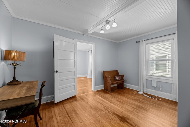 home office with light hardwood / wood-style floors, beamed ceiling, and crown molding