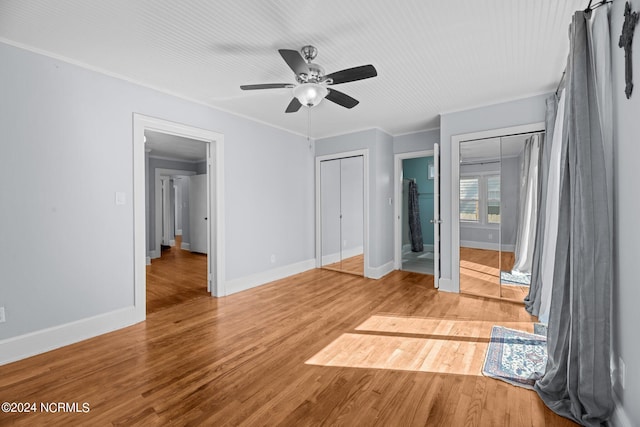 unfurnished bedroom with ornamental molding, hardwood / wood-style floors, and ceiling fan