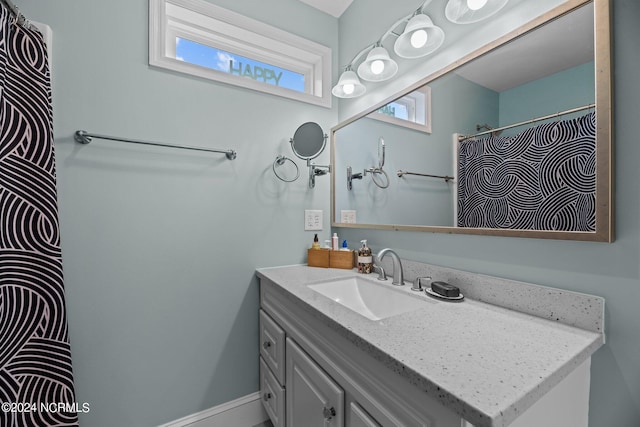 bathroom featuring a shower with curtain and vanity