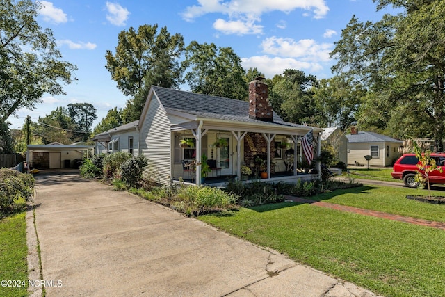 bungalow-style home with a front yard, a porch, and a carport