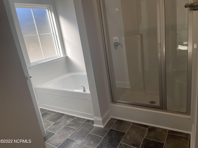 bathroom with independent shower and bath and plenty of natural light