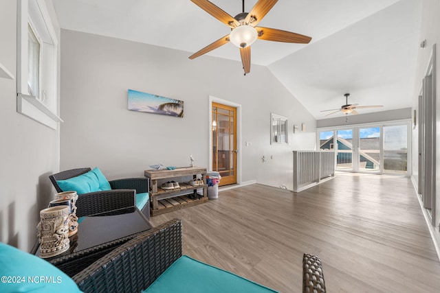 living area with vaulted ceiling, light wood-type flooring, and ceiling fan