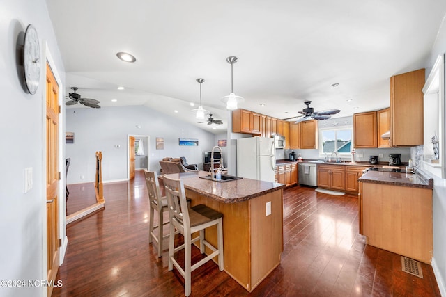 kitchen featuring white refrigerator, pendant lighting, dishwasher, dark hardwood / wood-style floors, and lofted ceiling