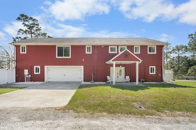 view of front of home with a front yard and a garage