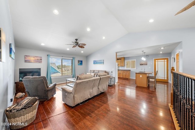 living room featuring lofted ceiling, ceiling fan, sink, and dark hardwood / wood-style floors