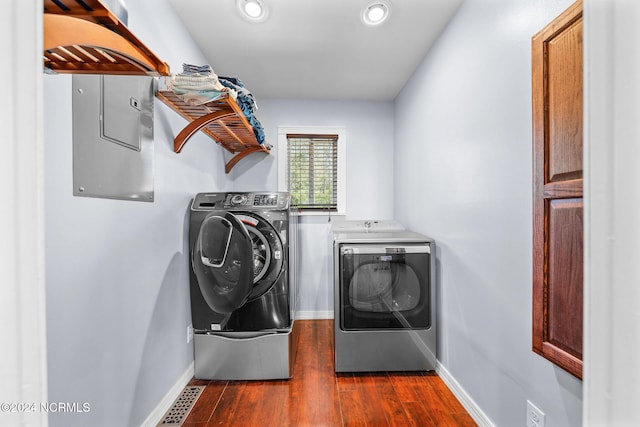 laundry area with separate washer and dryer and dark wood-type flooring