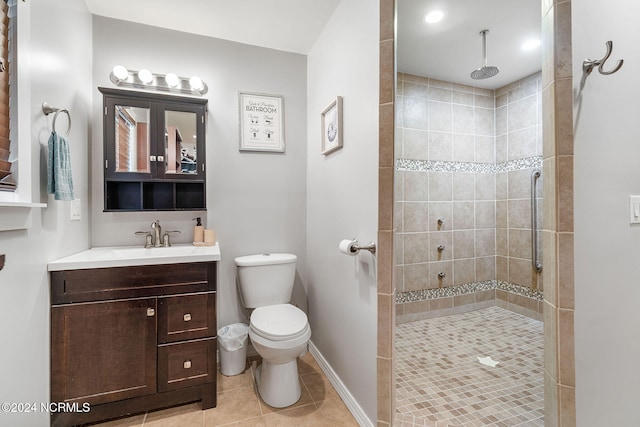 bathroom with tile patterned floors, a tile shower, vanity, and toilet