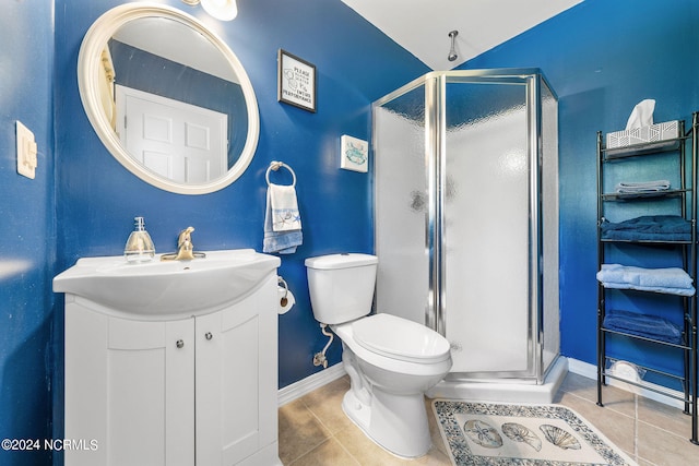 bathroom featuring vanity, a shower with shower door, toilet, and tile patterned flooring