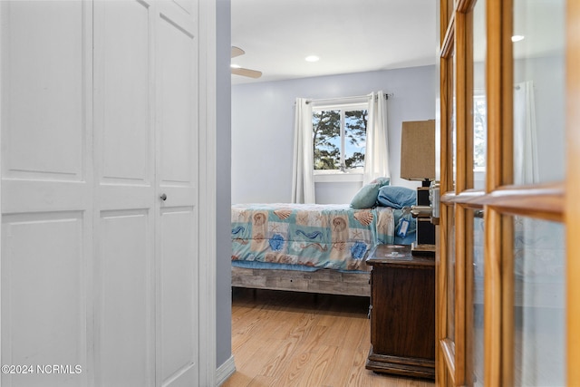 bedroom featuring ceiling fan, a closet, and light hardwood / wood-style floors