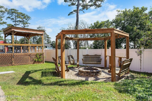 view of yard with a fire pit