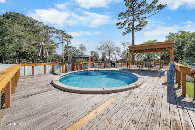 view of swimming pool with a gazebo and a deck