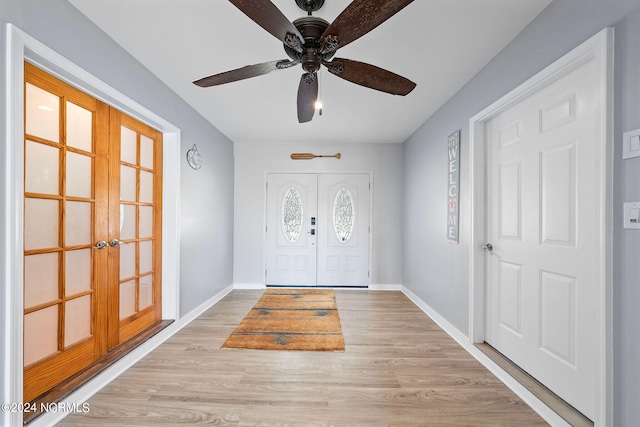 foyer with ceiling fan and light hardwood / wood-style floors