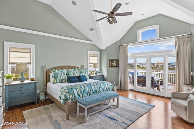 bedroom featuring access to exterior, dark wood-type flooring, and multiple windows