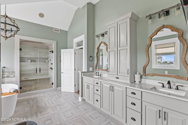 bathroom featuring plus walk in shower, vaulted ceiling, an inviting chandelier, and vanity