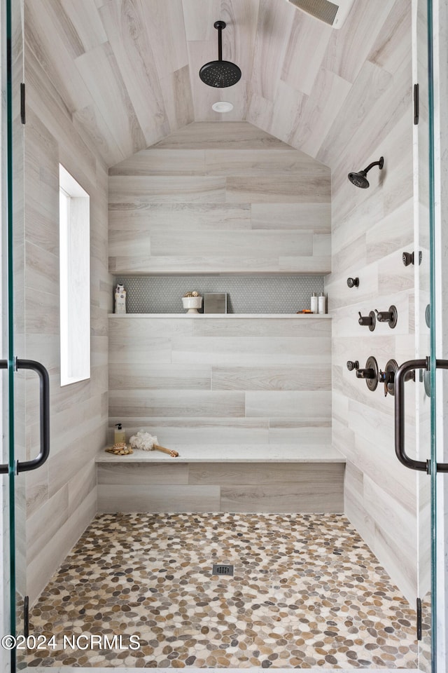 bathroom with lofted ceiling and an enclosed shower