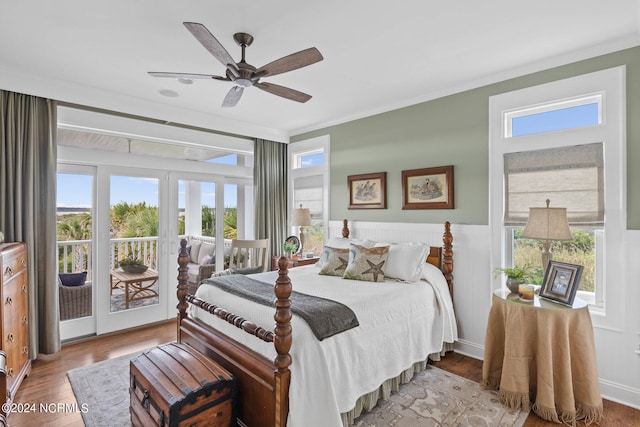 bedroom with multiple windows, light wood-type flooring, ceiling fan, and access to exterior