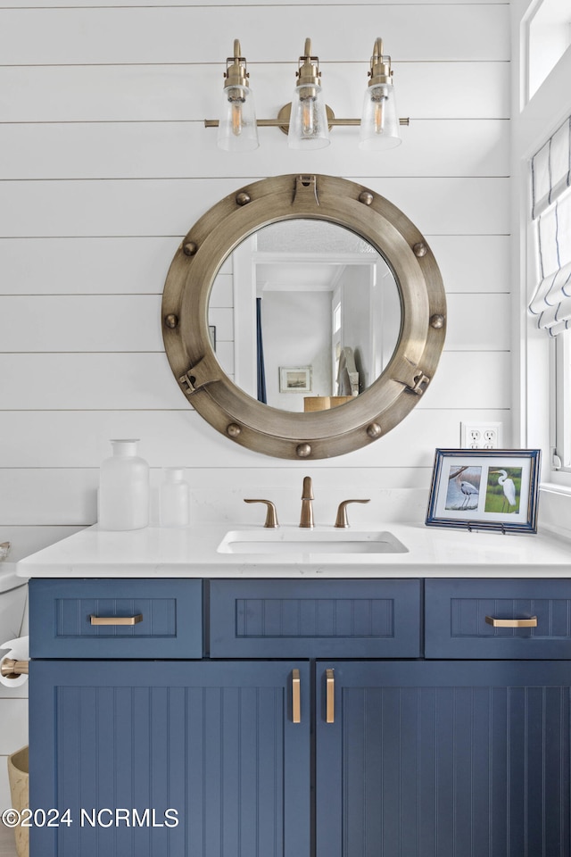 bathroom with wood walls and vanity