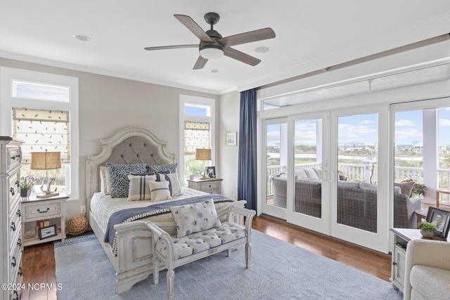 bedroom with wood-type flooring, crown molding, ceiling fan, french doors, and access to outside