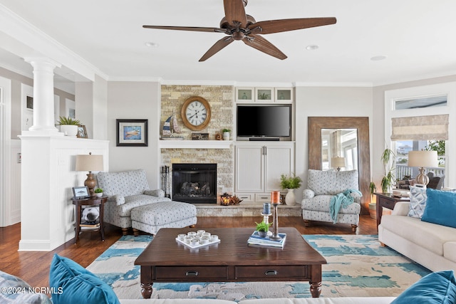 living room with ceiling fan, dark hardwood / wood-style floors, a fireplace, and crown molding