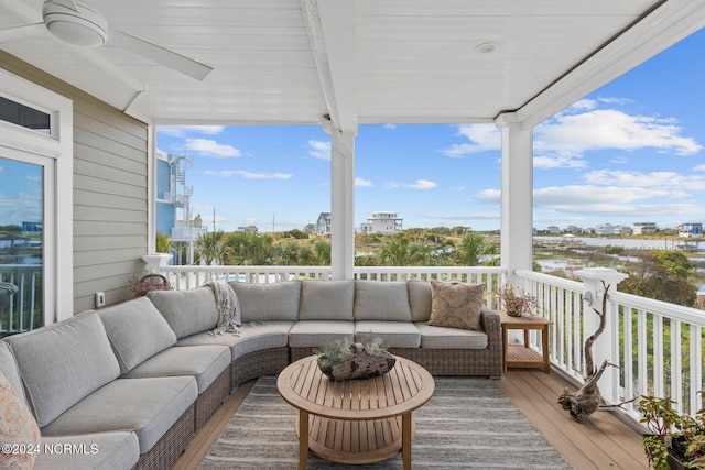 wooden terrace with ceiling fan and an outdoor hangout area