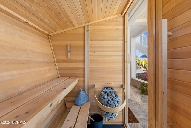 view of sauna featuring wooden walls and wood ceiling