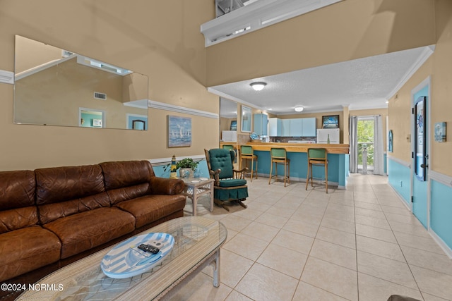 tiled living room featuring crown molding and a textured ceiling