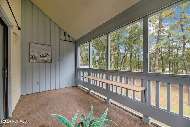 unfurnished sunroom featuring lofted ceiling and a wealth of natural light