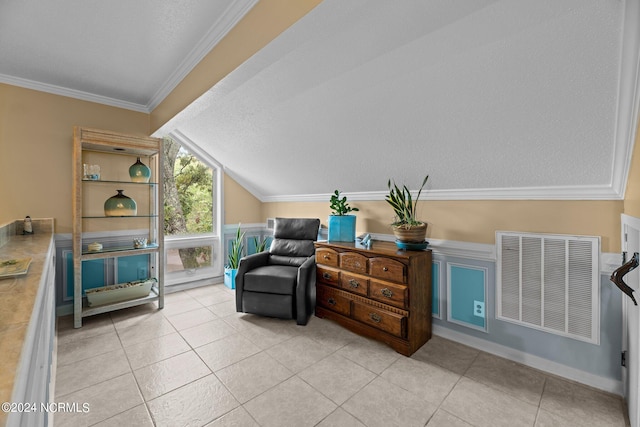 living area with vaulted ceiling, a textured ceiling, ornamental molding, and light tile patterned floors