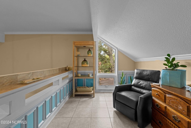 sitting room with crown molding, a textured ceiling, vaulted ceiling, and light tile patterned floors