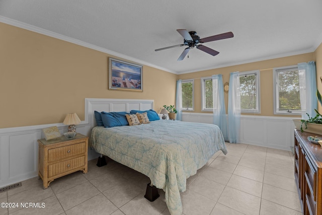 bedroom with ceiling fan, crown molding, and light tile patterned flooring