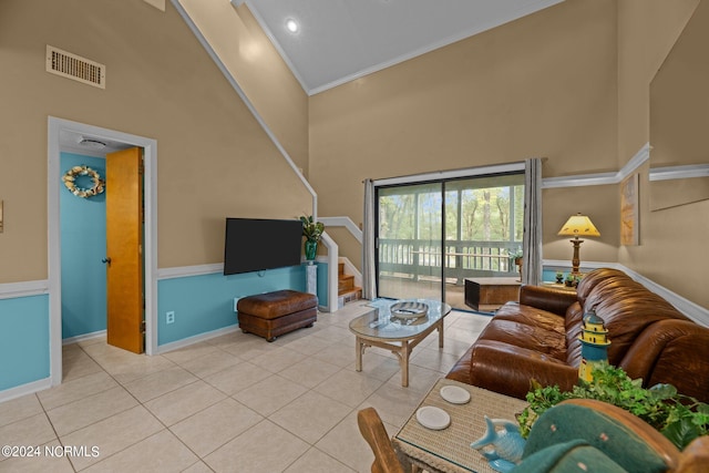 tiled living room with ornamental molding and high vaulted ceiling