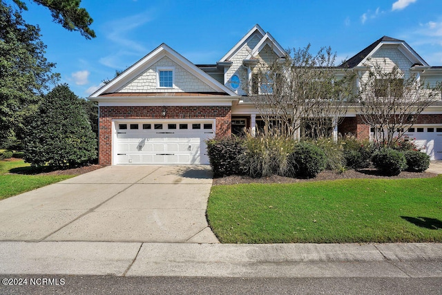 view of front of property with a front yard and a garage