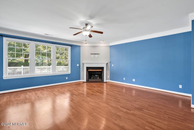 unfurnished living room featuring hardwood / wood-style flooring, ceiling fan, and ornamental molding